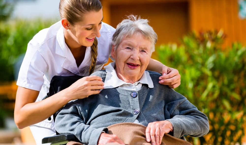 Senior woman in nursing home with nurse - Umbrella Home Care
